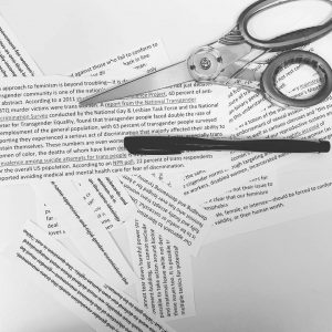 This image shows an early, typed draft of this blog entry that the author printed out, cut into strips, and was experimenting with in terms of re-arrangement. The pieces are laid at different angles, and we see both a pen and a pair of scissors.